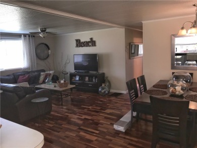 This cozy corner-lot home is full of potential and ready for on Barefoot Bay Golf Course in Florida - for sale on GolfHomes.com, golf home, golf lot