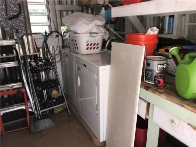 This cozy corner-lot home is full of potential and ready for on Barefoot Bay Golf Course in Florida - for sale on GolfHomes.com, golf home, golf lot