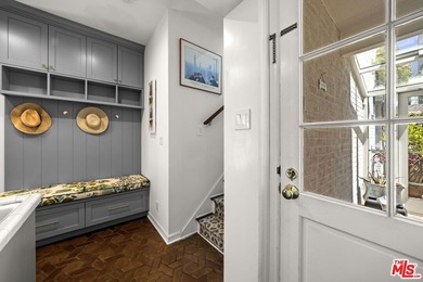 Tucked behind lush landscaping on one of the most coveted and on Los Angeles Country Club in California - for sale on GolfHomes.com, golf home, golf lot