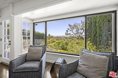 Tucked behind lush landscaping on one of the most coveted and on Los Angeles Country Club in California - for sale on GolfHomes.com, golf home, golf lot