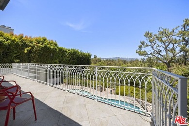 Tucked behind lush landscaping on one of the most coveted and on Los Angeles Country Club in California - for sale on GolfHomes.com, golf home, golf lot