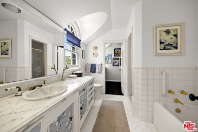 Tucked behind lush landscaping on one of the most coveted and on Los Angeles Country Club in California - for sale on GolfHomes.com, golf home, golf lot