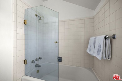 Tucked behind lush landscaping on one of the most coveted and on Los Angeles Country Club in California - for sale on GolfHomes.com, golf home, golf lot