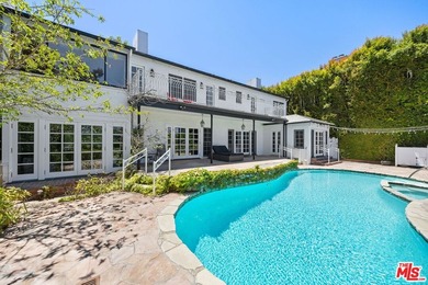 Tucked behind lush landscaping on one of the most coveted and on Los Angeles Country Club in California - for sale on GolfHomes.com, golf home, golf lot