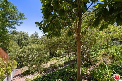 Tucked behind lush landscaping on one of the most coveted and on Los Angeles Country Club in California - for sale on GolfHomes.com, golf home, golf lot