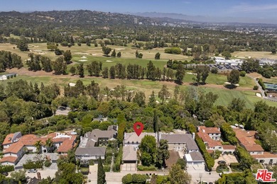 Tucked behind lush landscaping on one of the most coveted and on Los Angeles Country Club in California - for sale on GolfHomes.com, golf home, golf lot