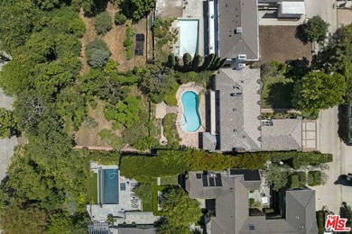 Tucked behind lush landscaping on one of the most coveted and on Los Angeles Country Club in California - for sale on GolfHomes.com, golf home, golf lot