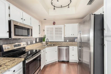Tucked inside the beautifully landscaped Village Square Condos on Westbrook Village Golf Club in Arizona - for sale on GolfHomes.com, golf home, golf lot