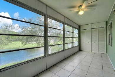 Experience serene waterfront living in this beautifully on Hillsboro Pines Golf in Florida - for sale on GolfHomes.com, golf home, golf lot