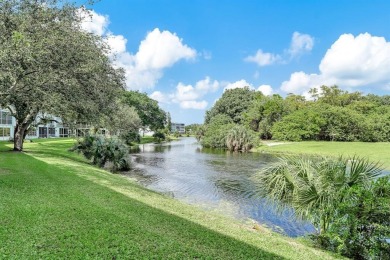 Experience serene waterfront living in this beautifully on Hillsboro Pines Golf in Florida - for sale on GolfHomes.com, golf home, golf lot