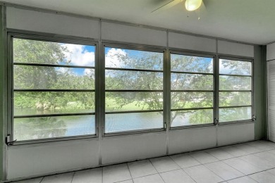 Experience serene waterfront living in this beautifully on Hillsboro Pines Golf in Florida - for sale on GolfHomes.com, golf home, golf lot