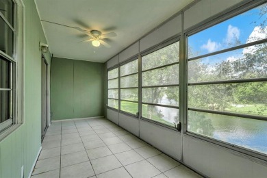 Experience serene waterfront living in this beautifully on Hillsboro Pines Golf in Florida - for sale on GolfHomes.com, golf home, golf lot