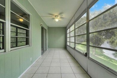 Experience serene waterfront living in this beautifully on Hillsboro Pines Golf in Florida - for sale on GolfHomes.com, golf home, golf lot