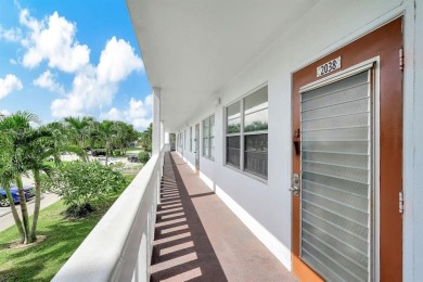 Experience serene waterfront living in this beautifully on Hillsboro Pines Golf in Florida - for sale on GolfHomes.com, golf home, golf lot