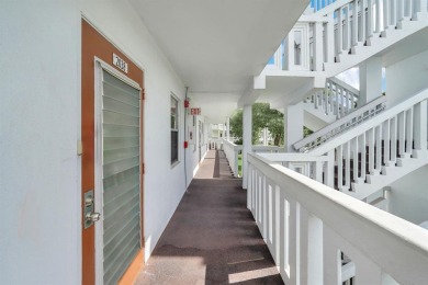 Experience serene waterfront living in this beautifully on Hillsboro Pines Golf in Florida - for sale on GolfHomes.com, golf home, golf lot