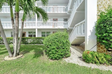 Experience serene waterfront living in this beautifully on Hillsboro Pines Golf in Florida - for sale on GolfHomes.com, golf home, golf lot