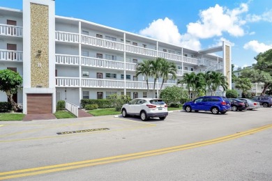 Experience serene waterfront living in this beautifully on Hillsboro Pines Golf in Florida - for sale on GolfHomes.com, golf home, golf lot