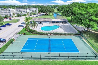 Experience serene waterfront living in this beautifully on Hillsboro Pines Golf in Florida - for sale on GolfHomes.com, golf home, golf lot