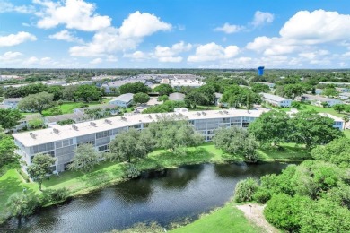 Experience serene waterfront living in this beautifully on Hillsboro Pines Golf in Florida - for sale on GolfHomes.com, golf home, golf lot