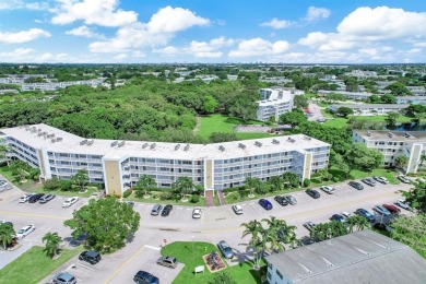 Experience serene waterfront living in this beautifully on Hillsboro Pines Golf in Florida - for sale on GolfHomes.com, golf home, golf lot