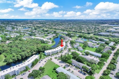 Experience serene waterfront living in this beautifully on Hillsboro Pines Golf in Florida - for sale on GolfHomes.com, golf home, golf lot
