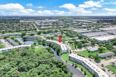 Experience serene waterfront living in this beautifully on Hillsboro Pines Golf in Florida - for sale on GolfHomes.com, golf home, golf lot