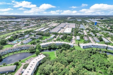 Experience serene waterfront living in this beautifully on Hillsboro Pines Golf in Florida - for sale on GolfHomes.com, golf home, golf lot