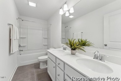This semi-custom home in Lake Royale offers 3BR/2.5BA and a on River Golf and County Club at Lake Royale in North Carolina - for sale on GolfHomes.com, golf home, golf lot