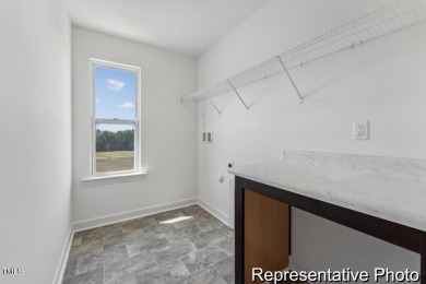 This semi-custom home in Lake Royale offers 3BR/2.5BA and a on River Golf and County Club at Lake Royale in North Carolina - for sale on GolfHomes.com, golf home, golf lot