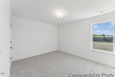 This semi-custom home in Lake Royale offers 3BR/2.5BA and a on River Golf and County Club at Lake Royale in North Carolina - for sale on GolfHomes.com, golf home, golf lot