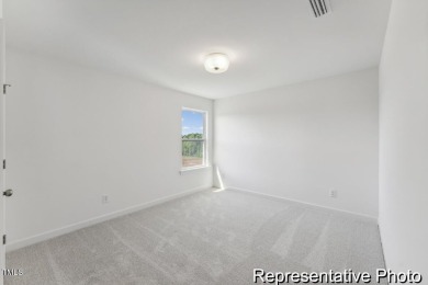 This semi-custom home in Lake Royale offers 3BR/2.5BA and a on River Golf and County Club at Lake Royale in North Carolina - for sale on GolfHomes.com, golf home, golf lot