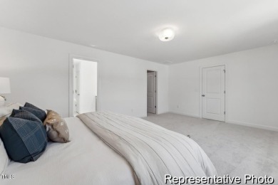 This semi-custom home in Lake Royale offers 3BR/2.5BA and a on River Golf and County Club at Lake Royale in North Carolina - for sale on GolfHomes.com, golf home, golf lot