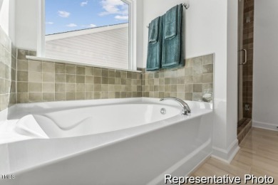This semi-custom home in Lake Royale offers 3BR/2.5BA and a on River Golf and County Club at Lake Royale in North Carolina - for sale on GolfHomes.com, golf home, golf lot