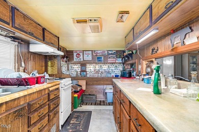 Escape to Lake Royale with this unique weekend retreat at 106 & on River Golf and Country Club at Lake Royale in North Carolina - for sale on GolfHomes.com, golf home, golf lot