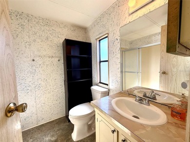 This very affordable two bedroom, two bathroom home is located on Apollo Beach Golf and Sea Club in Florida - for sale on GolfHomes.com, golf home, golf lot
