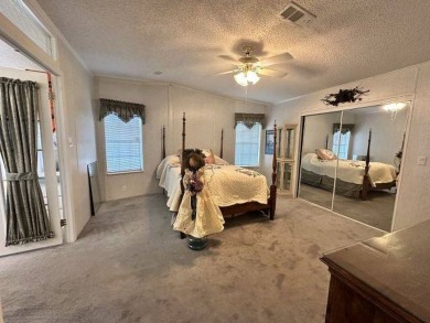 This charming home is perfectly located near the clubhouse and on Four Lakes Golf Club in Florida - for sale on GolfHomes.com, golf home, golf lot