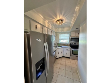 Come see this beautiful first floor end unit in charming on The Little Club in Florida - for sale on GolfHomes.com, golf home, golf lot