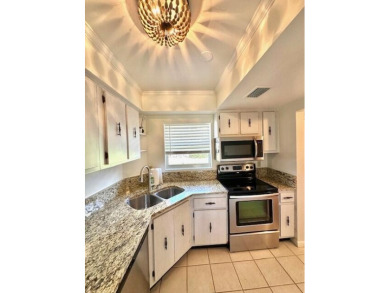 Come see this beautiful first floor end unit in charming on The Little Club in Florida - for sale on GolfHomes.com, golf home, golf lot