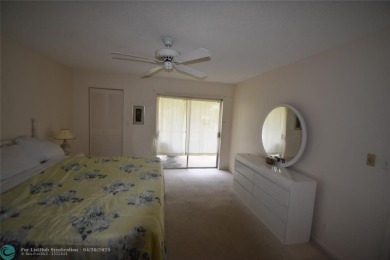 Discover convenience, and scenic beauty in this lovely 2-bedroom on Inverrary Country Club in Florida - for sale on GolfHomes.com, golf home, golf lot
