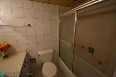 Discover convenience, and scenic beauty in this lovely 2-bedroom on Inverrary Country Club in Florida - for sale on GolfHomes.com, golf home, golf lot