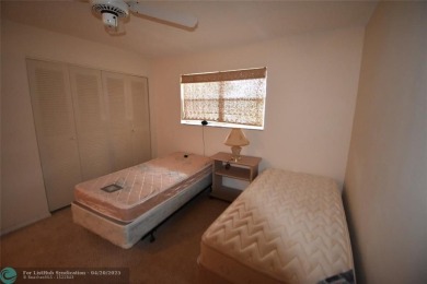 Discover convenience, and scenic beauty in this lovely 2-bedroom on Inverrary Country Club in Florida - for sale on GolfHomes.com, golf home, golf lot