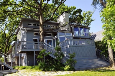 This unique lake home features large windows, offering on Lake Kiowa Golf Course in Texas - for sale on GolfHomes.com, golf home, golf lot