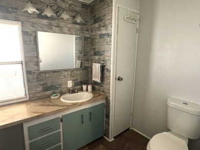 This lovely 2-bedroom, 2-bathroom gem overlooks a picturesque on Lake Henry Golf Club in Florida - for sale on GolfHomes.com, golf home, golf lot