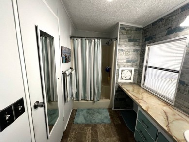 This lovely 2-bedroom, 2-bathroom gem overlooks a picturesque on Lake Henry Golf Club in Florida - for sale on GolfHomes.com, golf home, golf lot