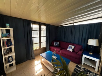 This lovely 2-bedroom, 2-bathroom gem overlooks a picturesque on Lake Henry Golf Club in Florida - for sale on GolfHomes.com, golf home, golf lot