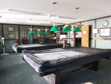 This lovely 2-bedroom, 2-bathroom gem overlooks a picturesque on Lake Henry Golf Club in Florida - for sale on GolfHomes.com, golf home, golf lot