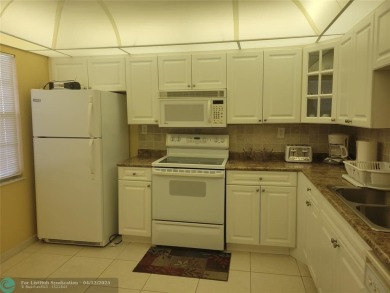 ELEGANT, IMMACULATE AND SPACIOUS UNIT WITH SERENE VIEWS OF GOLF on Wynmoor Golf Course in Florida - for sale on GolfHomes.com, golf home, golf lot