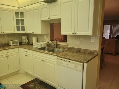 ELEGANT, IMMACULATE AND SPACIOUS UNIT WITH SERENE VIEWS OF GOLF on Wynmoor Golf Course in Florida - for sale on GolfHomes.com, golf home, golf lot