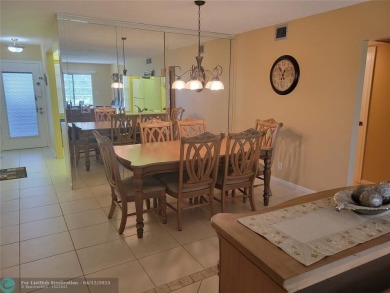 ELEGANT, IMMACULATE AND SPACIOUS UNIT WITH SERENE VIEWS OF GOLF on Wynmoor Golf Course in Florida - for sale on GolfHomes.com, golf home, golf lot