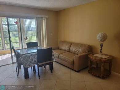 ELEGANT, IMMACULATE AND SPACIOUS UNIT WITH SERENE VIEWS OF GOLF on Wynmoor Golf Course in Florida - for sale on GolfHomes.com, golf home, golf lot